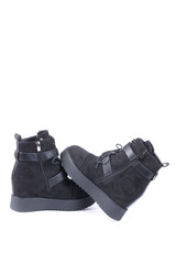 Female winter boots on high soles on a white background