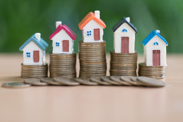 Mini house on stack of coins,Money and house,  Mortgage, Savings money for buy house and loan to business investment for real estate concept. Invesment and Risk Management.