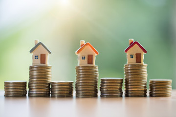 Mini house on stack of coins,Money and house,  Mortgage, Savings money for buy house and loan to...