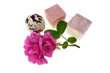 Bath bombs set with rose extract. round and square bath truffle, pink rose flower close-up isolated on white background.Organic cosmetics for 