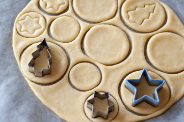 Cooking homemade Christmas cookies. Cutting out dough.