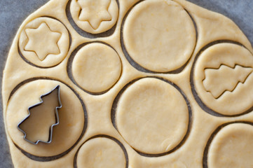 Cooking homemade Christmas cookies. Cutting out dough.