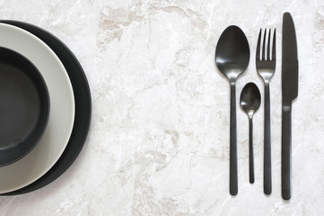 Black and white tableware on marble