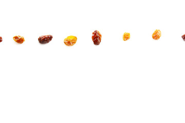 Golden raisins and black raisins on white background