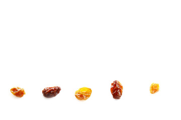 Golden raisins and black raisins on white background