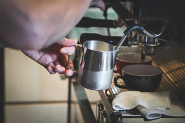 Frothing coffee in a cafe
