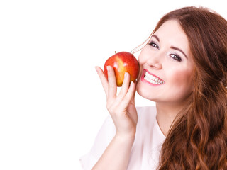 Woman holds apple fruit close to face, isolated