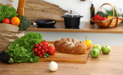 Desk  with many fresh vegetables and fruits in the kitchen. Cooking, vegetarian and shopping concept