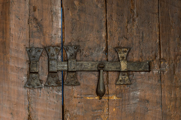 Old antique metal lock on wooden shutters on the windows