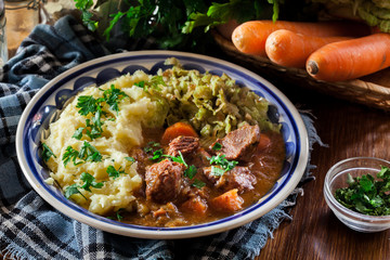 Traditional irish stew served with potatoes and cabbage