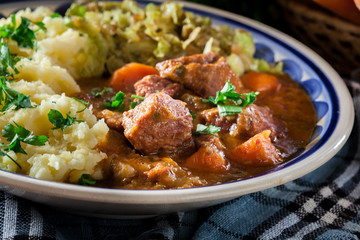Traditional irish stew served with potatoes and cabbage