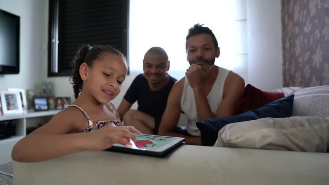 Gay Family with Adopted Child Using Tablet at Home