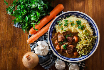 Traditional irish stew served with potatoes and cabbage