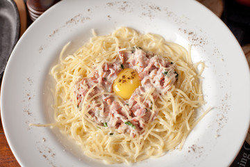 vermicelli with fried eggs and meat on a white plate