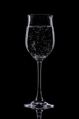 glass of white wine isolated on black background