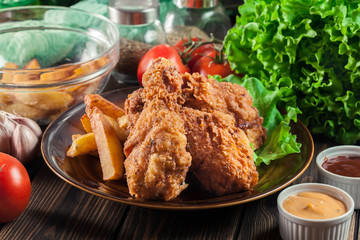 Crispy fried kentucky chicken legs with french fries