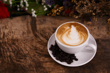 Cappuccino and latte art on the wood table. Free hand pouring some milk on the coffee. Morning breakfast with coffee.