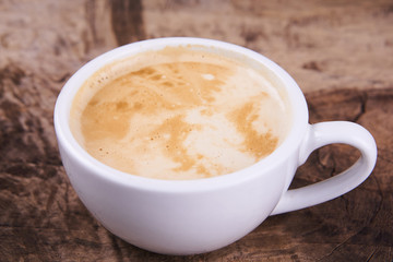 Cappuccino and latte art on the wood table. Free hand pouring some milk on the coffee. Morning breakfast with coffee.