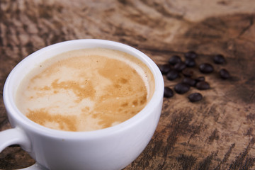 Cappuccino and latte art on the wood table. Free hand pouring some milk on the coffee. Morning breakfast with coffee.