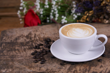 Cappuccino and latte art on the wood table. Free hand pouring some milk on the coffee. Morning breakfast with coffee.