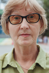Portrait of the elderly woman outside