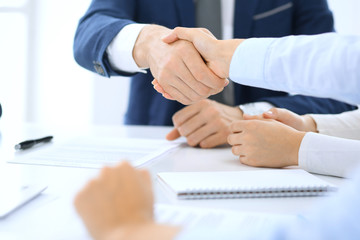 Group of business people or lawyers shaking hands finishing up a meeting , close-up. Success at negotiation and handshake concepts
