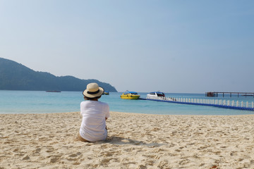 Fototapeta na wymiar Tourist sit on the beach, Maceold island , Myanmar