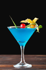 glass of delicious alcoholic cocktail on dark background