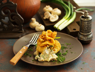 Russian crepes stuffed with mushrooms and cheese.