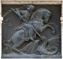 Saint George slaying the dragon relief on the building in the city of Lucca in Tuscany, Italy 