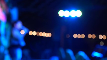 Abstract  low-light blur and bokeh of female singers are singing on stage and dancing in the night party.