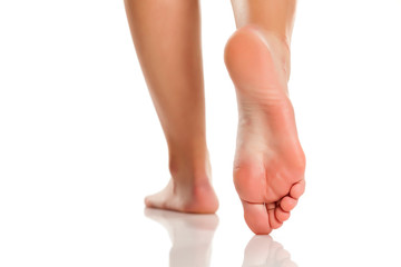 female bare feet on white background