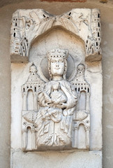 Fototapeta na wymiar Enthroned Madonna, portal of Santa Maria Forisportam church in Lucca, Tuscany, Italy