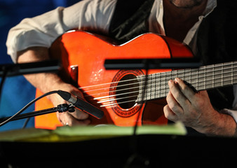 Close-up of a man's hands playing the classical guitar