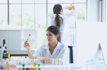 Scientist beautiful asian woman working with biopsy sample in laboratory