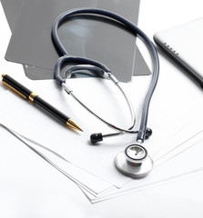 stethoscope,x-ray and pen on the table. photo with copy space