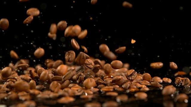 Roasted coffee beans falling on water 4k