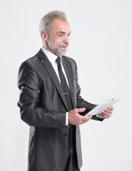 modern businessman reading text on a digital tablet.isolated on grey background