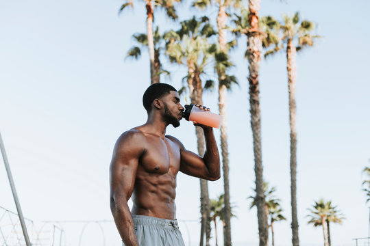 Muscular man drinking a protein shake