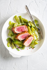 Fried tuna with young peas in pods