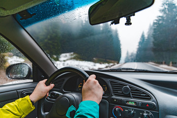 driving by snowed mountains road