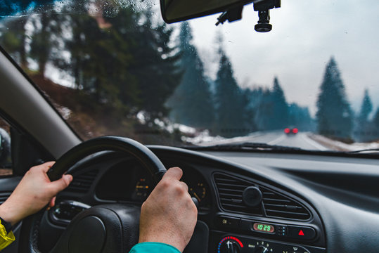 driving by snowed mountains road