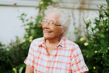 Happy senior woman in her garden