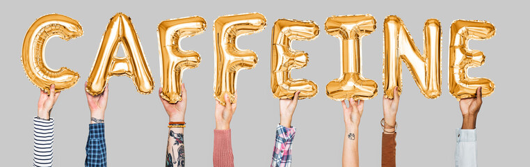Hands holding caffeine word in balloon letters