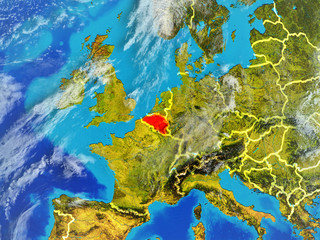 Fototapeta na wymiar Belgium from space on model of planet Earth with country borders. Extremely fine detail of planet surface and clouds.
