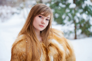 Close up portrait of a girl in an extravagant fox fur coat