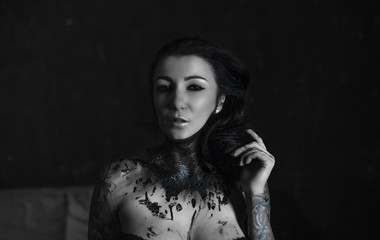 Black and white portrait of the artist with a make-up on her body