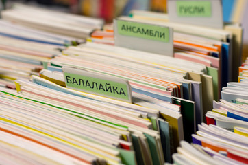 Edges of the multi-colored musical notebooks put in a row with the inscriptions in Russian...