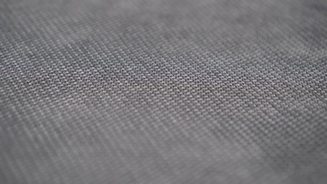 Grey textured fabric extremely close up