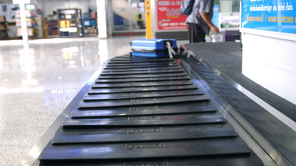 Airport baggage claim with luggage spinning around conveyor